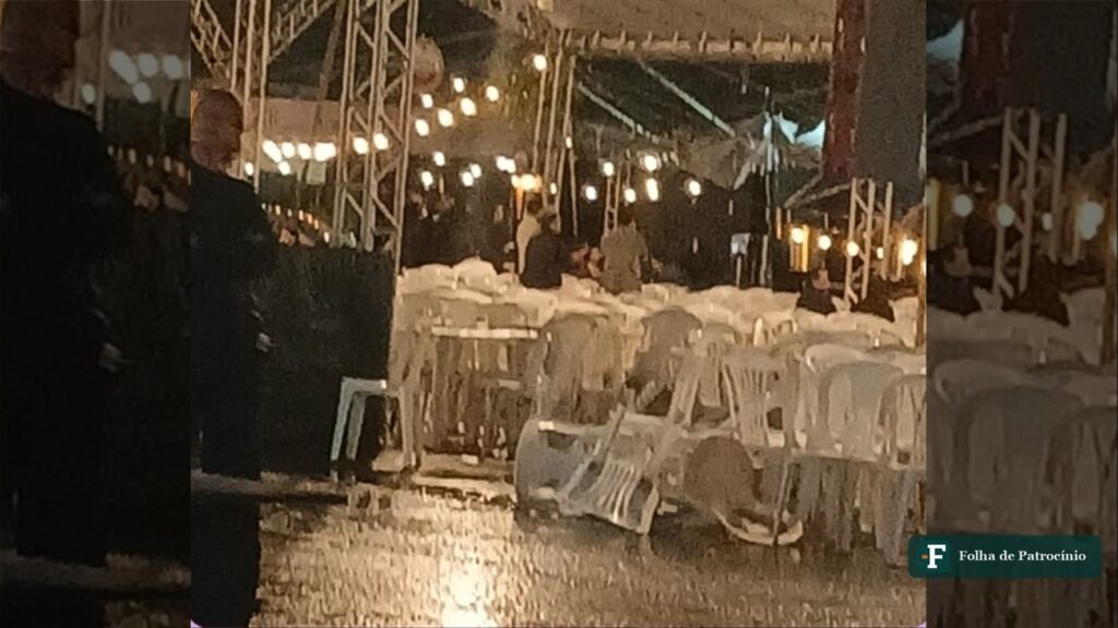Público e barracas iluminadas do Festival Gastronômico no Espaço Cultural em Patrocínio durante a noite de temporal
