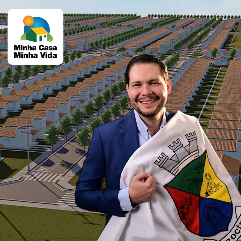 Habitação - Prefeito de Patrocínio com a bandeira do município e conjunto habitacional ao fundo; habitação em Patrocínio