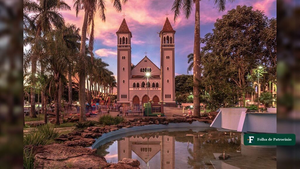 Igreja de duas torres numa praça de Patrocínio ao entardecer, refletida no lago, uma das igrejas de Patrocínio. Foto: Acervo/@patrociniomg