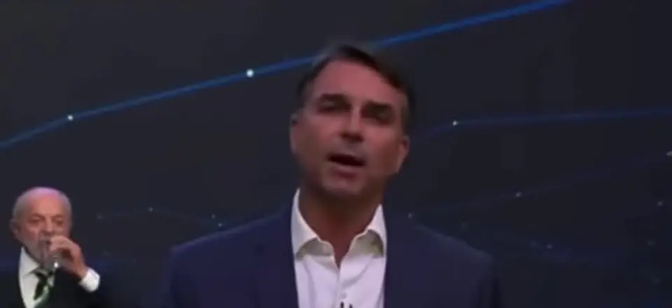 Flávio pede respeito a Lula no debate da Band; ao fundo, o presidente bebe água