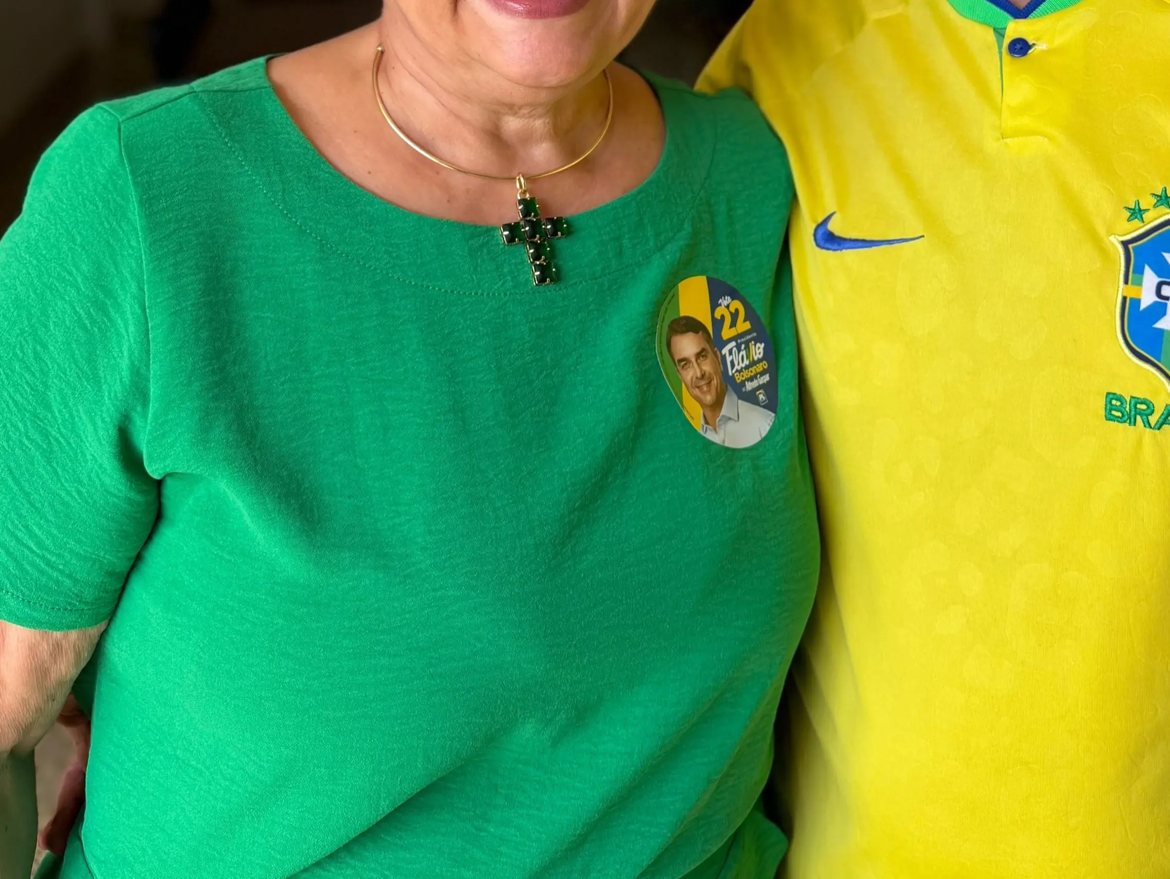 Maurício Cunha e Ana Valéria: detalhe do adesivo Vote 22 de Flávio Bolsonaro na blusa verde da secretária