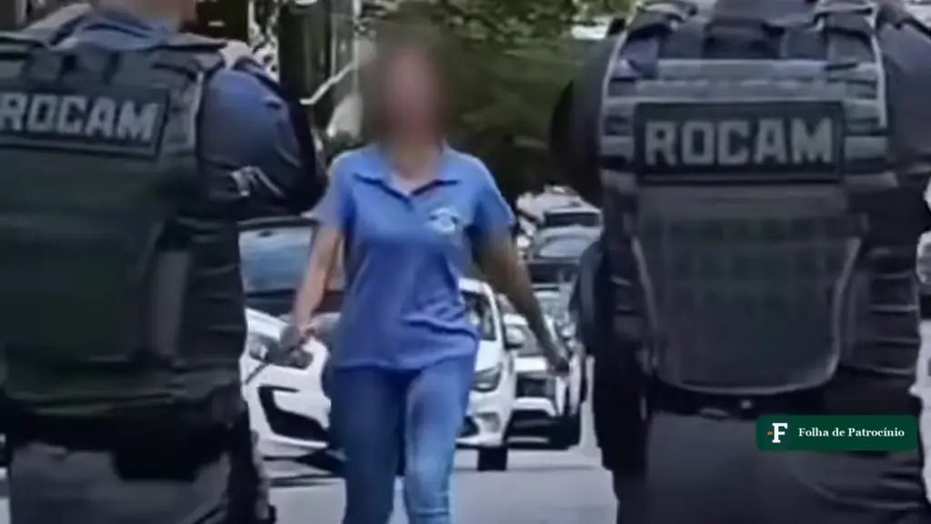 Mulher com o rosto desfocado entre dois policiais da Rocam pouco antes de ser baleada por PM em Pirituba